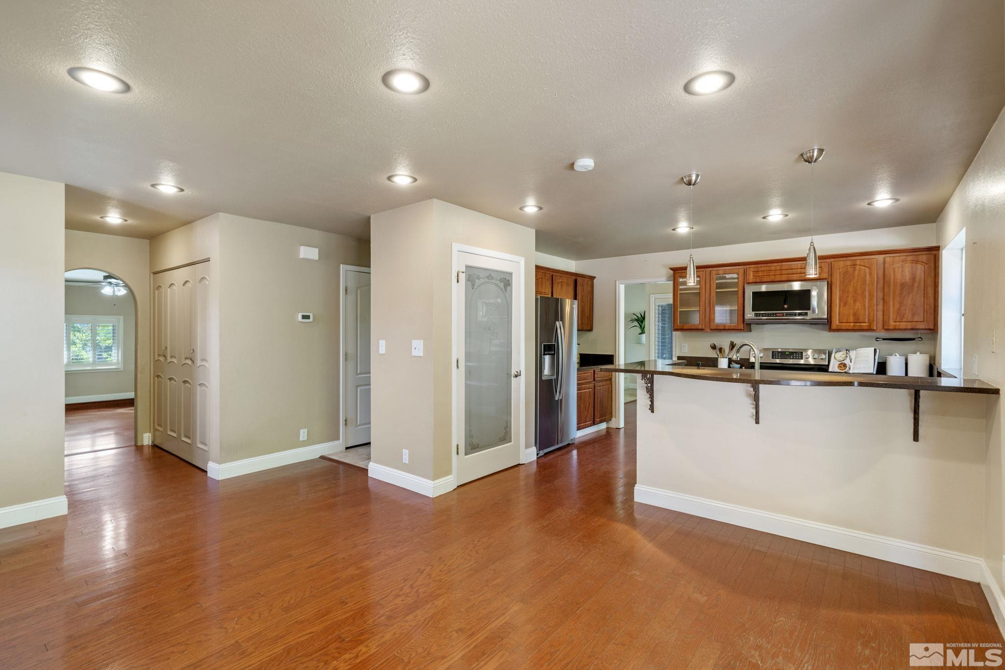 2197 Solitude Drive Reno, NV 89511 - Photo 15 of 40 a view of kitchen with stainless steel appliances refrigerator oven microwave and stove