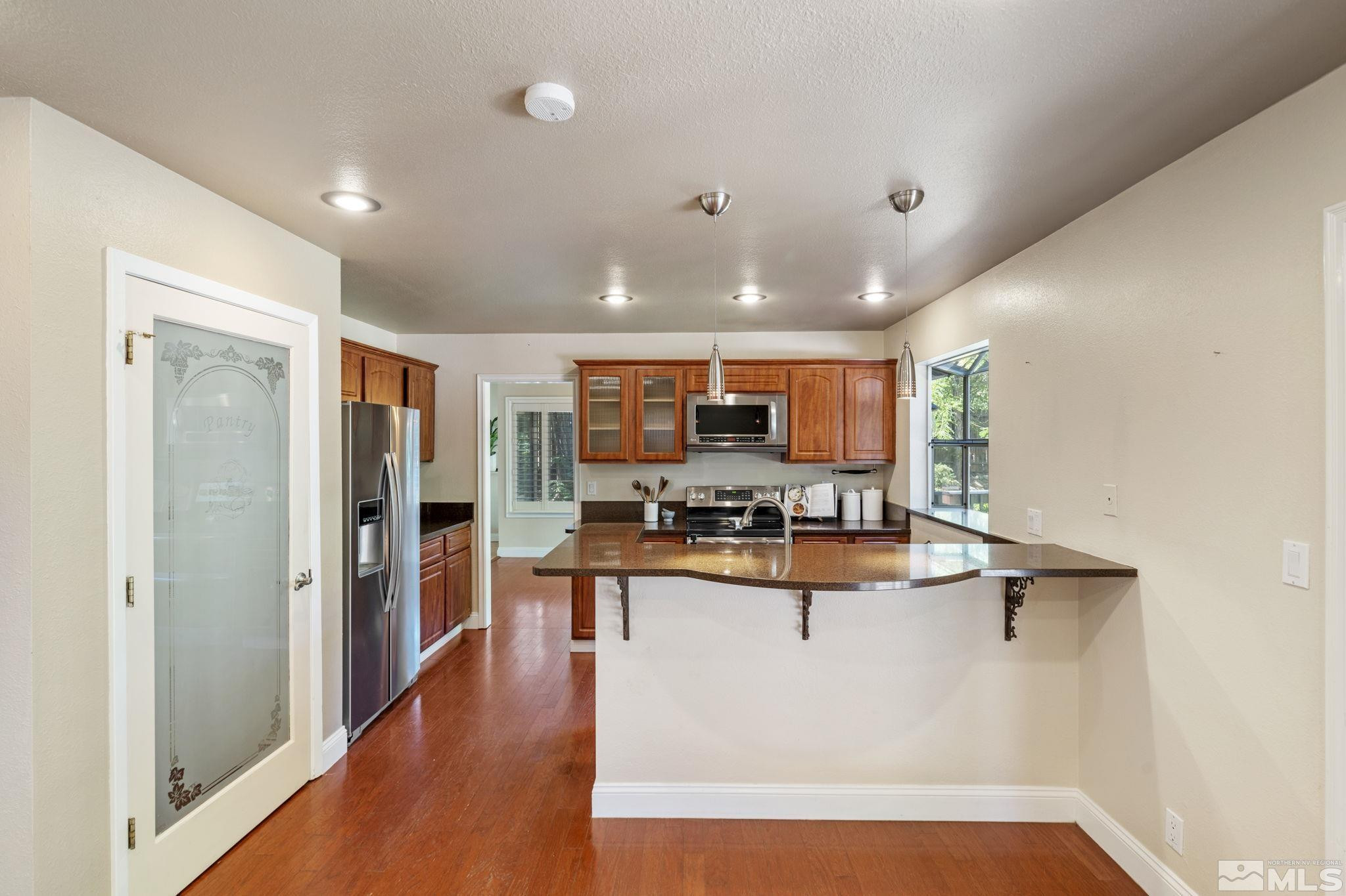 2197 Solitude Drive Reno, NV 89511 - Photo 16 of 40 a view of kitchen with cabinets and wooden floor