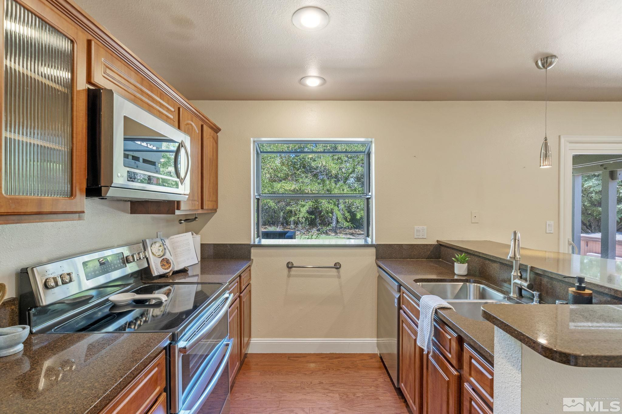 2197 Solitude Drive Reno, NV 89511 - Photo 18 of 40 a kitchen with a stove a sink and a refrigerator