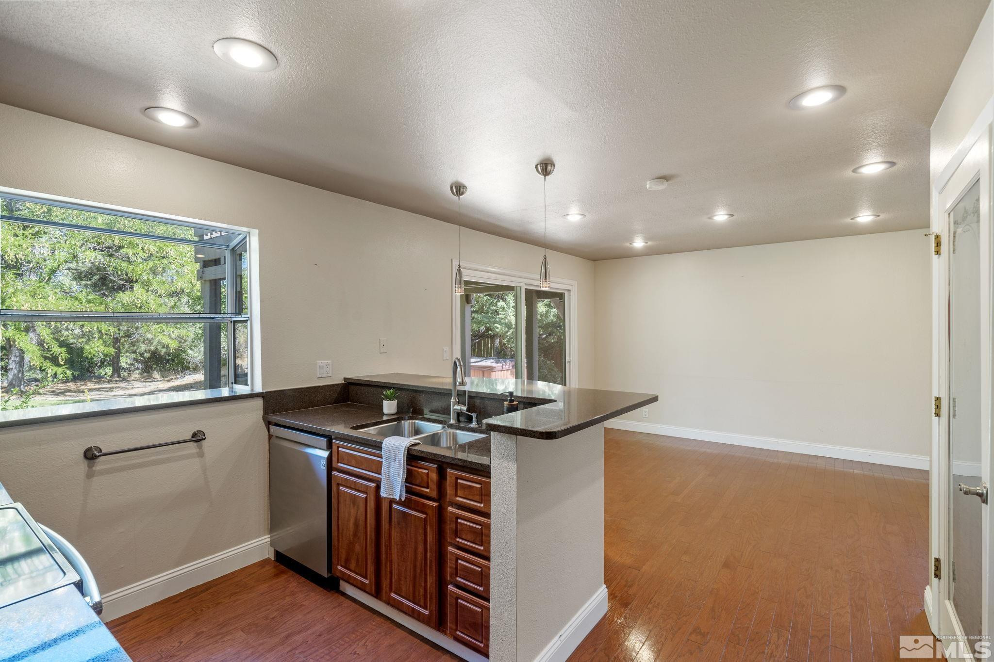 2197 Solitude Drive Reno, NV 89511 - Photo 19 of 40 a kitchen with stainless steel appliances granite countertop a stove a sink and a refrigerator