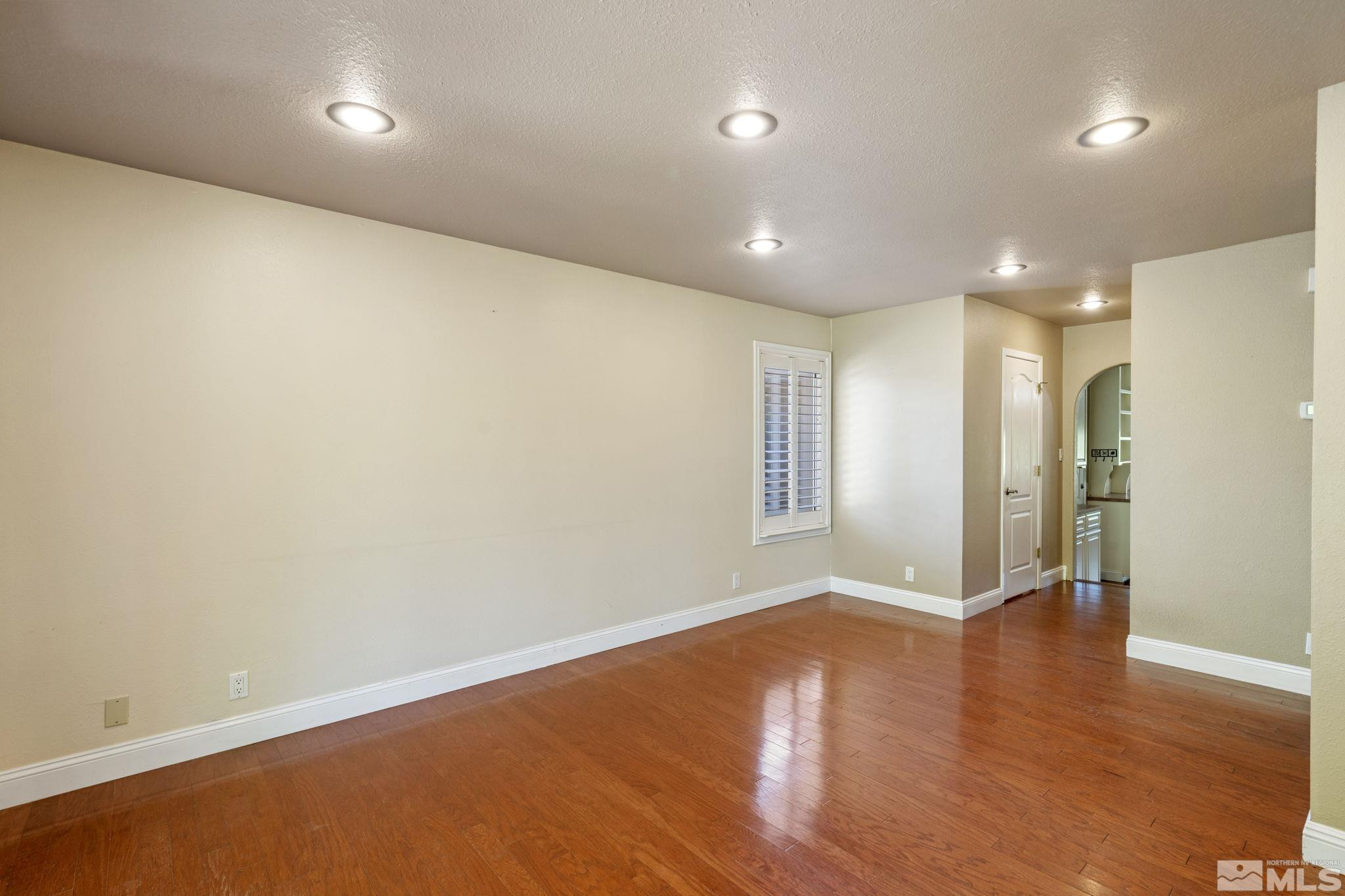 2197 Solitude Drive Reno, NV 89511 - Photo 21 of 40 an empty room with wooden floor and windows