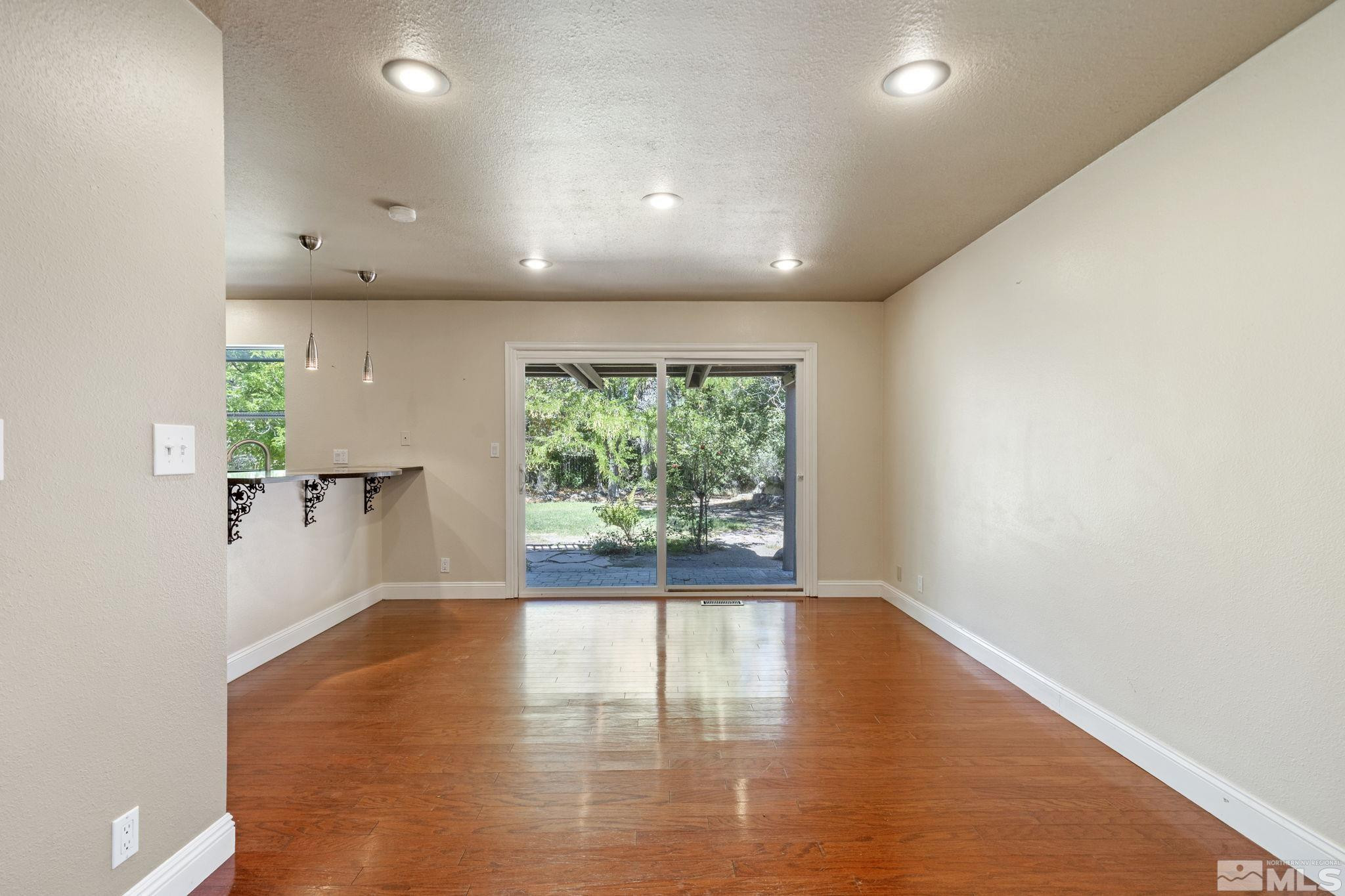 2197 Solitude Drive Reno, NV 89511 - Photo 22 of 40 an empty room with wooden floor and windows