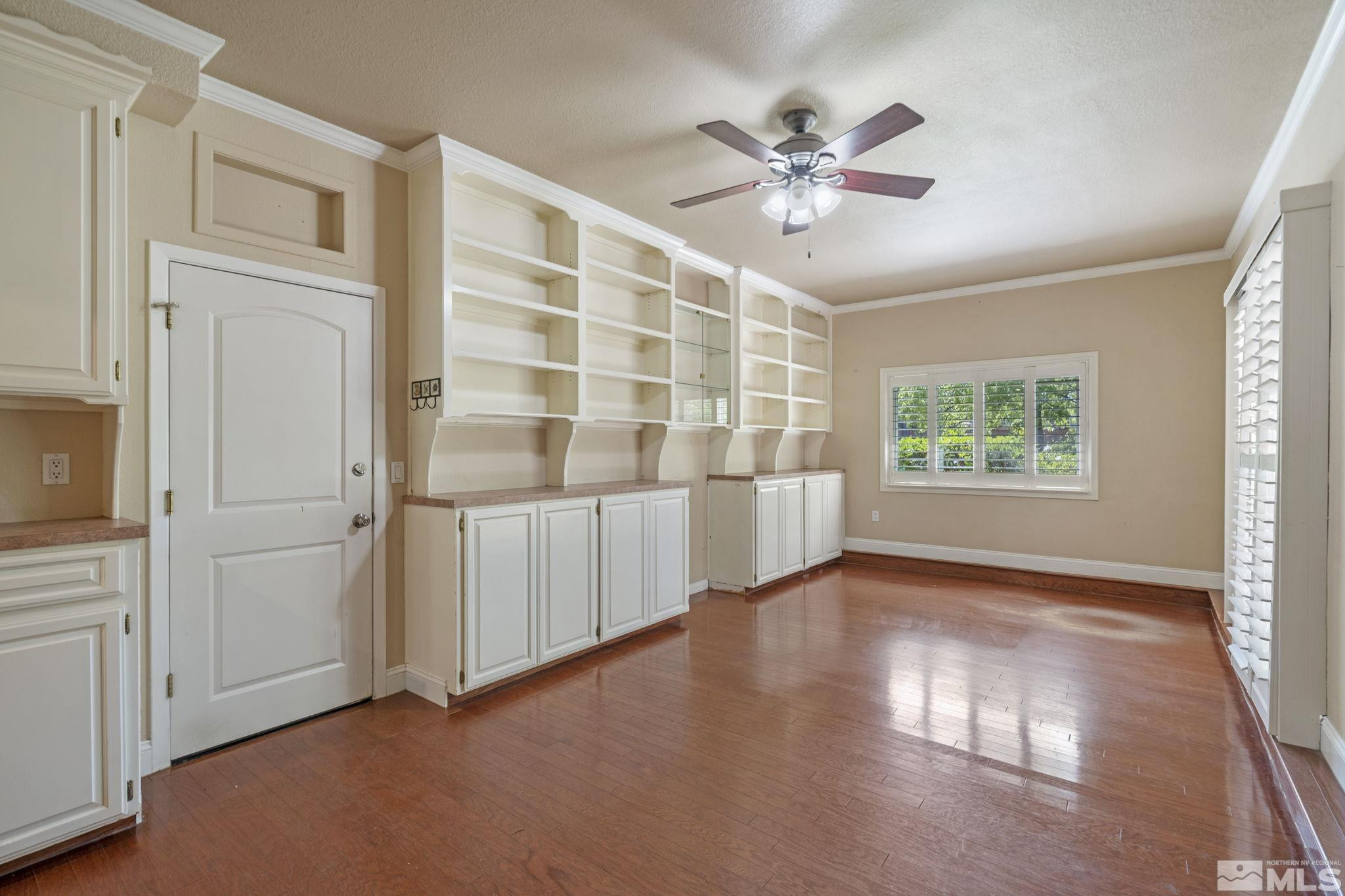 2197 Solitude Drive Reno, NV 89511 - Photo 24 of 40 a view of an empty room with a window and wooden floor