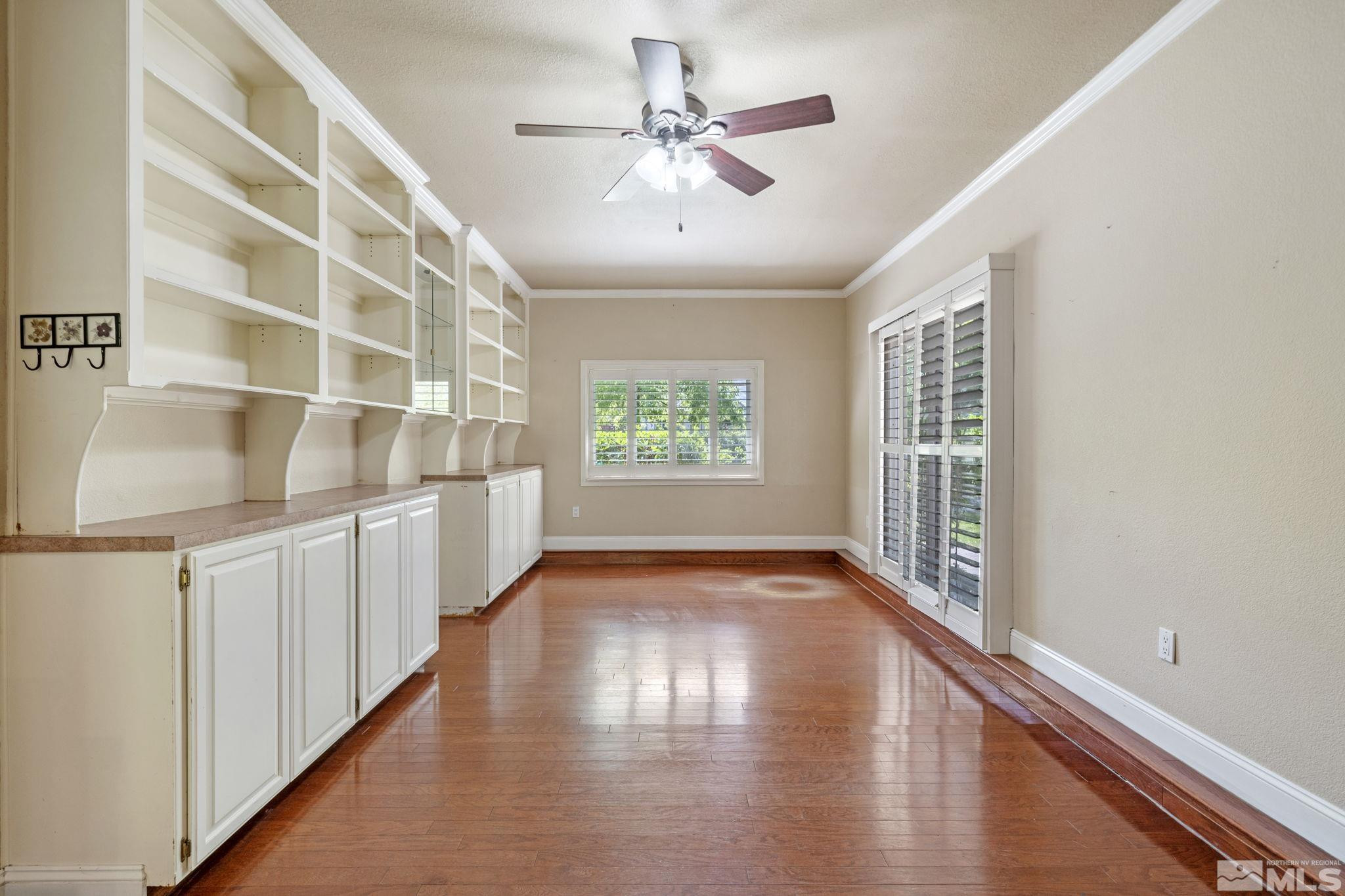 2197 Solitude Drive Reno, NV 89511 - Photo 26 of 40 a view of an empty room with window and wooden floor