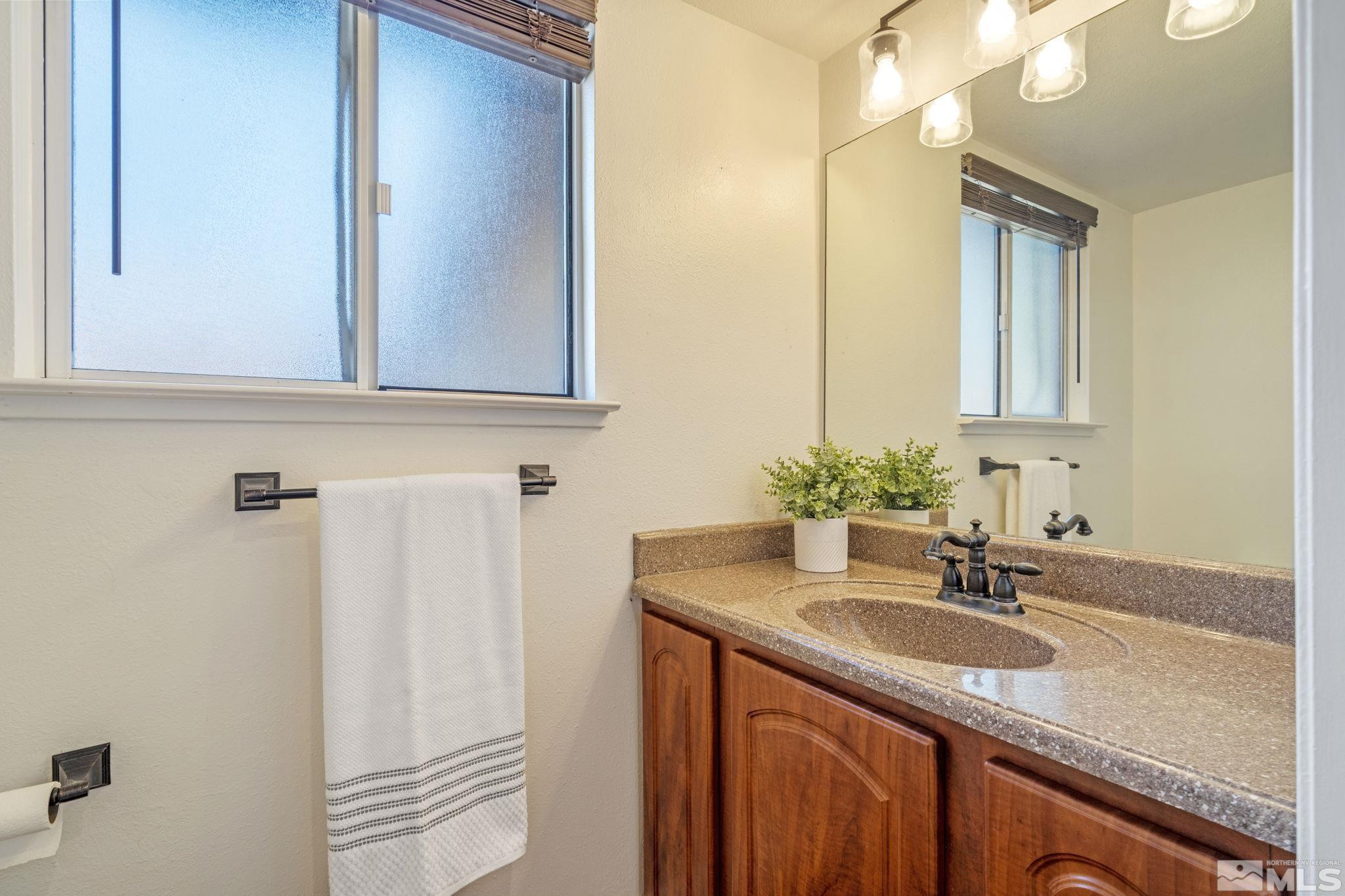 2197 Solitude Drive Reno, NV 89511 - Photo 27 of 40 a bathroom with a sink and a mirror