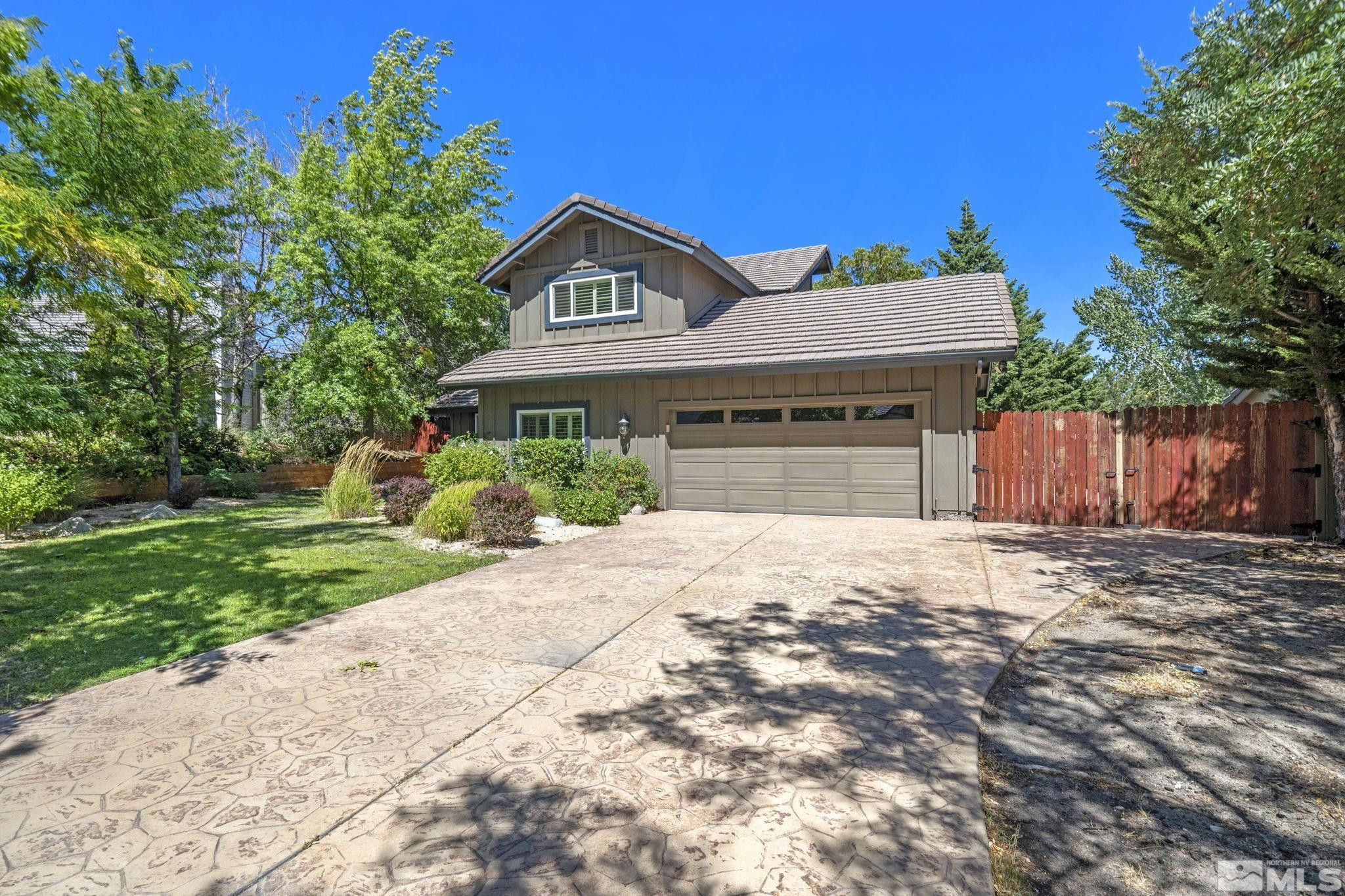 2197 Solitude Drive Reno, NV 89511 - Photo 3 of 40 a front view of a house with a yard and garage