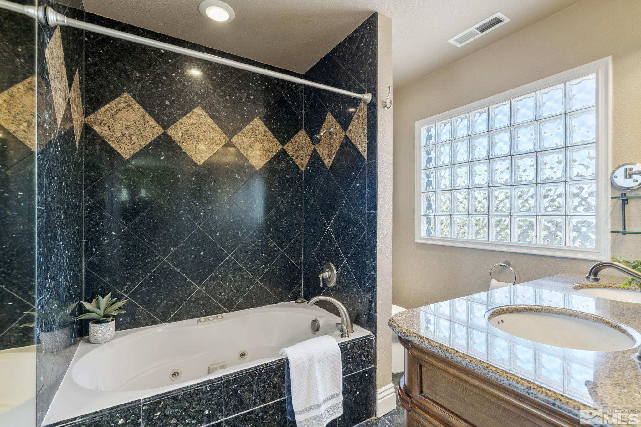 2197 Solitude Drive Reno, NV 89511 - Photo 31 of 40 a bathroom with a sink and a bathtub