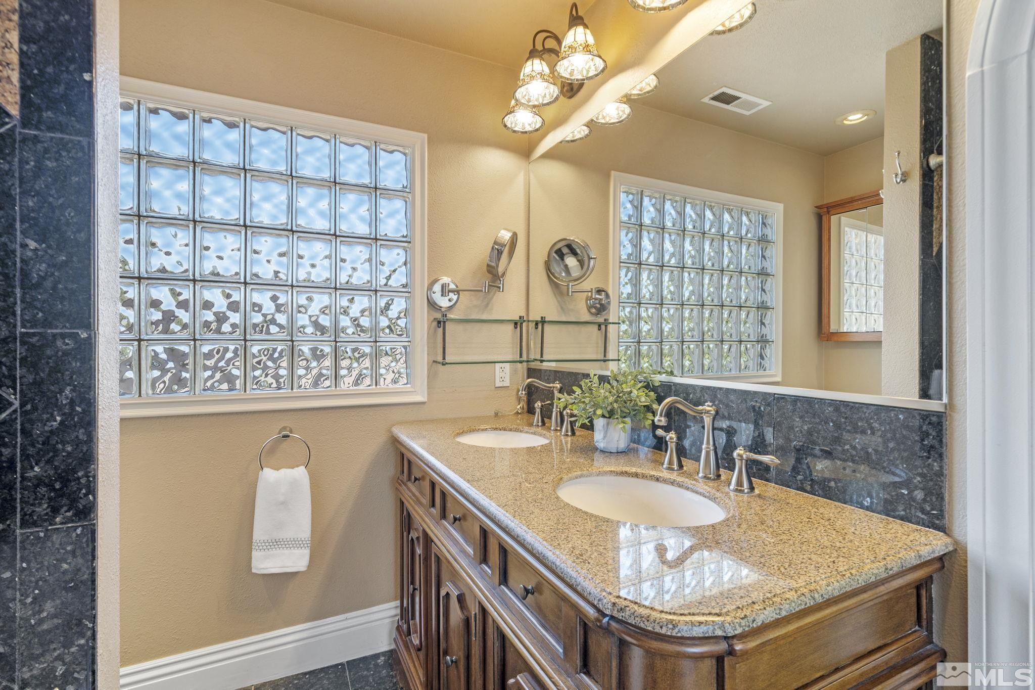 2197 Solitude Drive Reno, NV 89511 - Photo 32 of 40 a bathroom with a granite countertop sink a mirror and a window