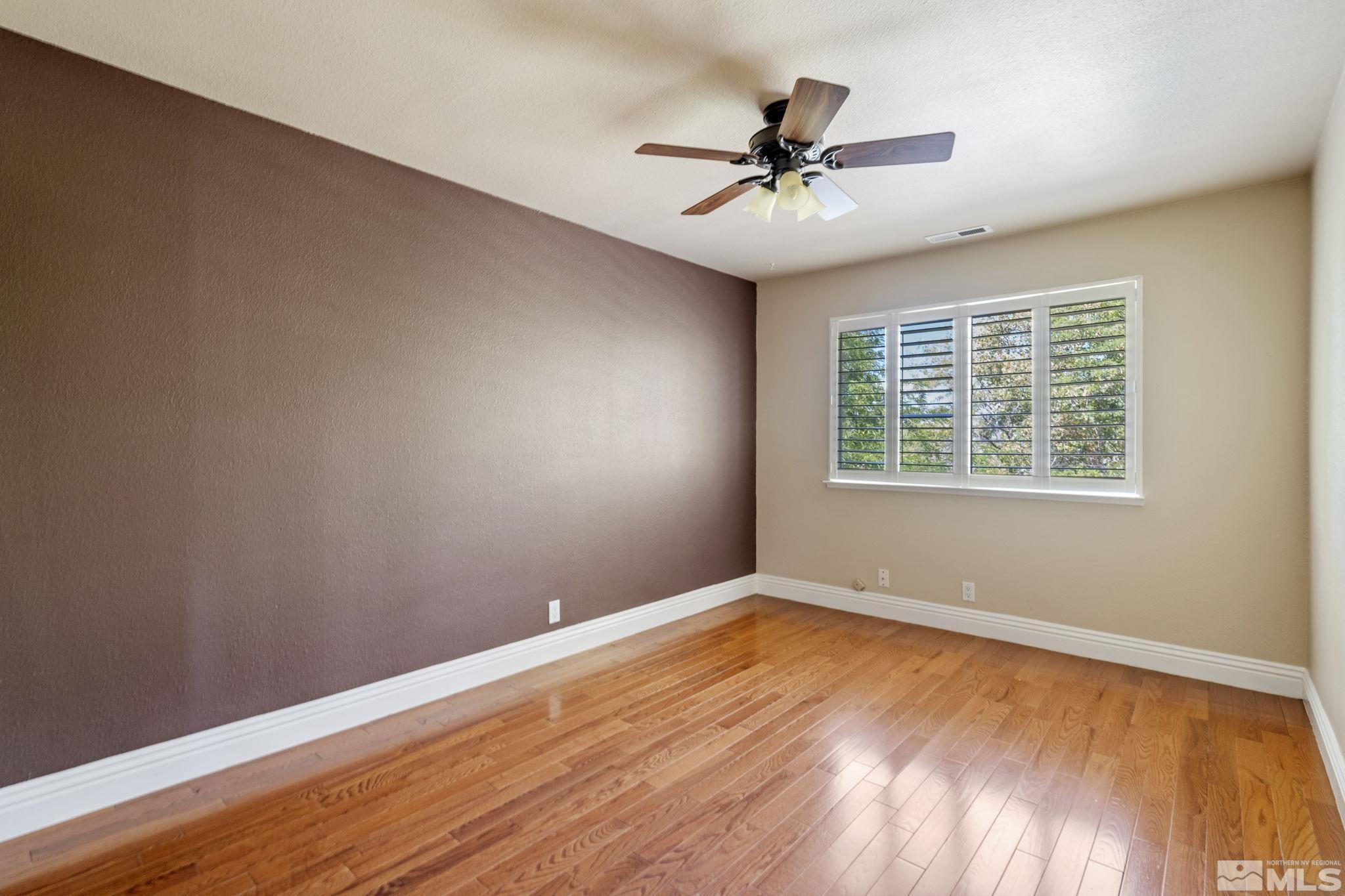 2197 Solitude Drive Reno, NV 89511 - Photo 34 of 40 a view of a room with wooden floor and windows