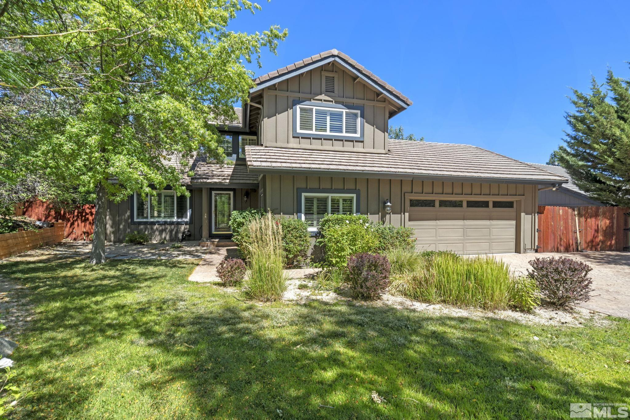 2197 Solitude Drive Reno, NV 89511 - Photo 4 of 40 a front view of a house with yard and green space