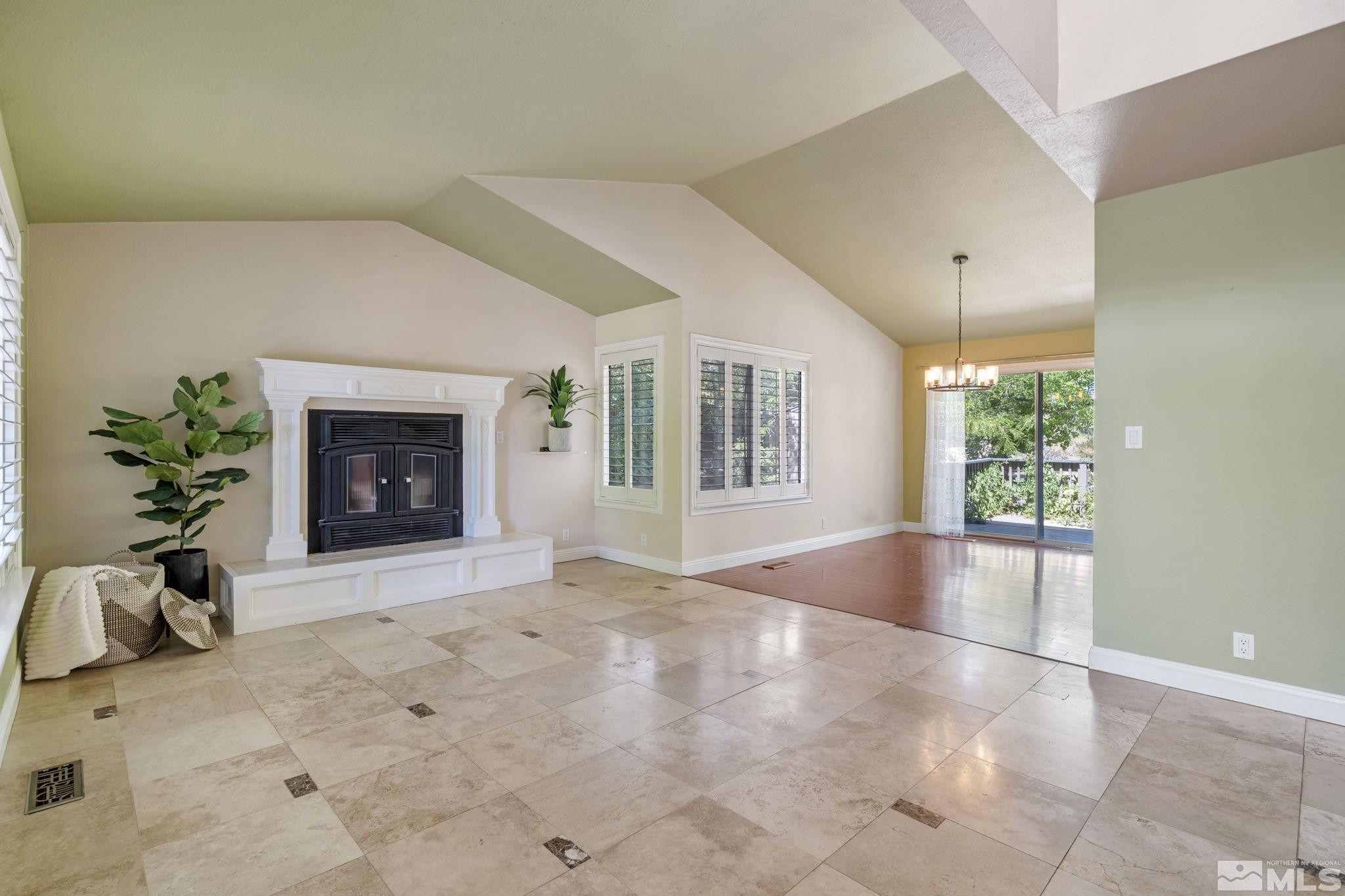 2197 Solitude Drive Reno, NV 89511 - Photo 6 of 40 a view of an empty room with a fireplace and a window