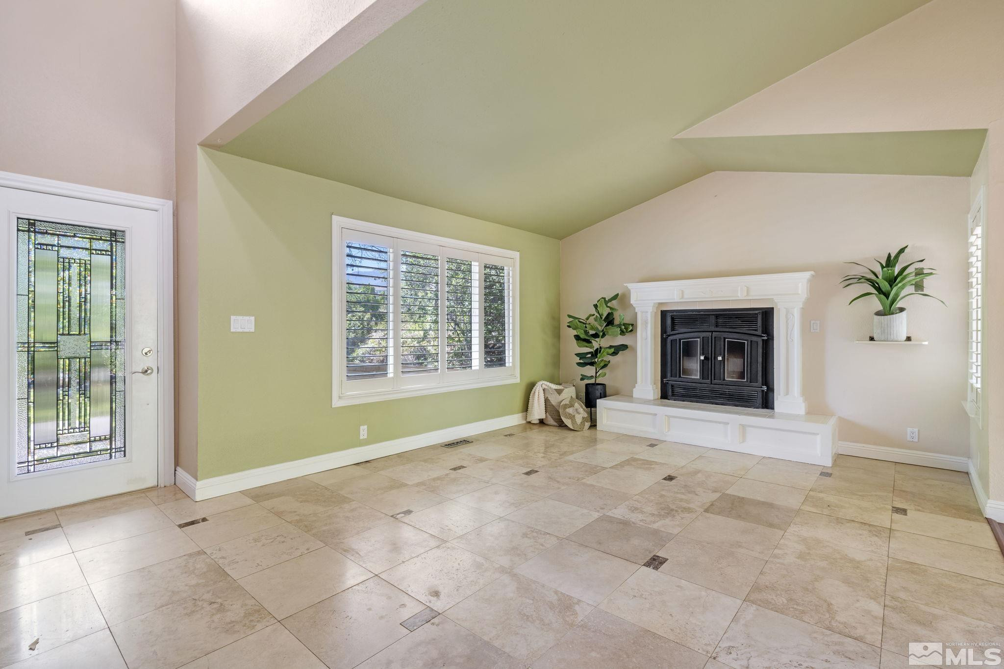 2197 Solitude Drive Reno, NV 89511 - Photo 8 of 40 an empty room with windows and fireplace
