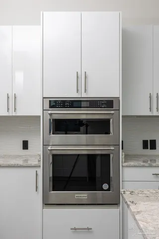 a stove top oven sitting inside of a kitchen