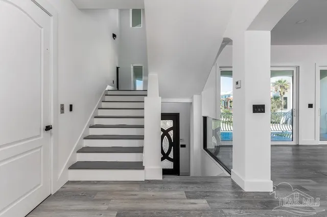 a view of entryway and hall with wooden floor