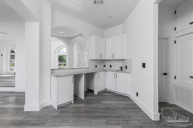 a view of kitchen with wooden floor and electronic appliances