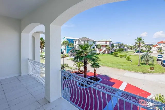a view of a balcony with yard