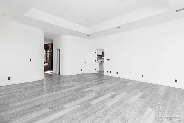 an empty room with wooden floor