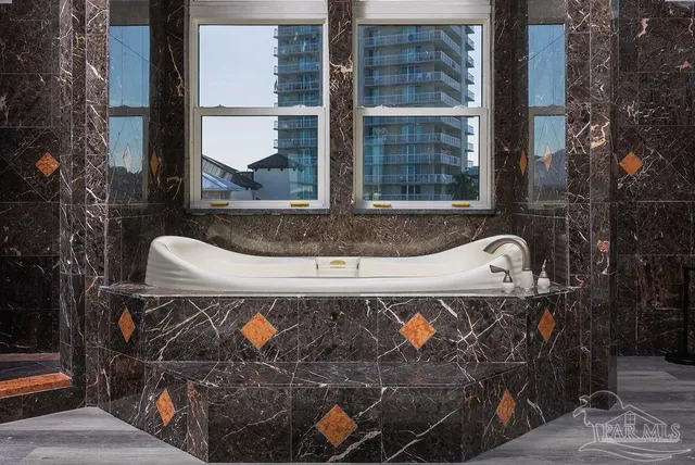 a view of fountain and a bench in front of a building