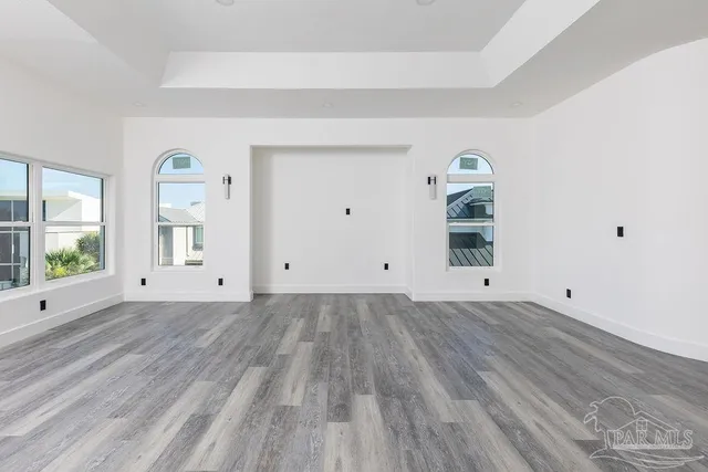 a view of a room with wooden floor and window