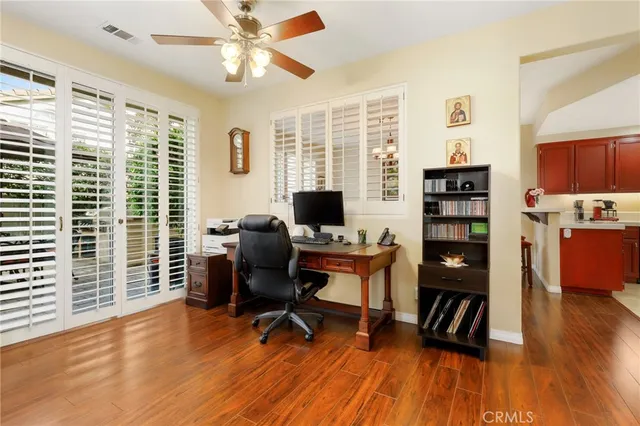 a view of a workspace with furniture and a window