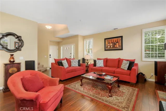 a living room with furniture a rug and a window