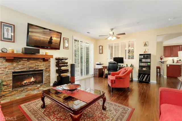 a living room with furniture a flat screen tv and a fireplace