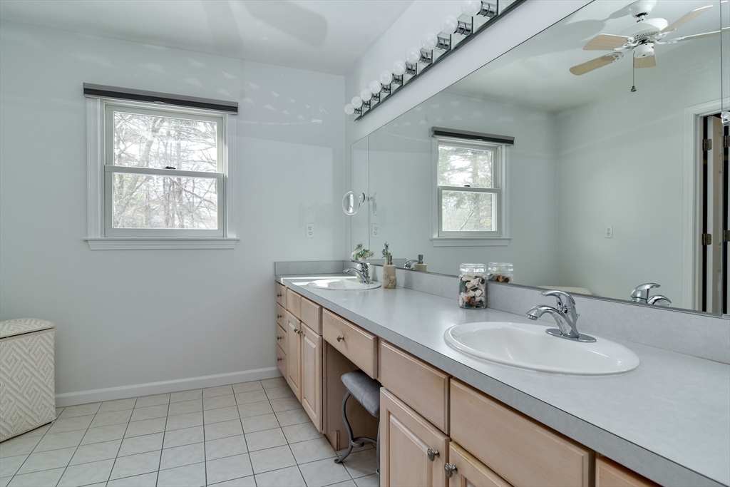 10 Sundance Way Natick, MA 01760 - Photo 25 of 40 a bathroom with a sink a vanity and a mirror