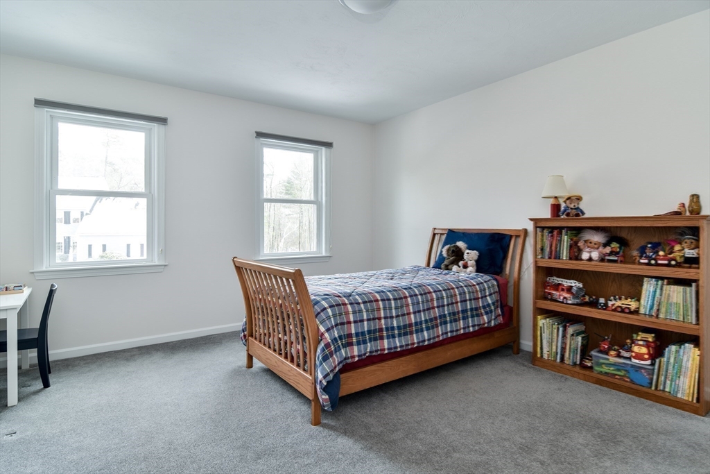 10 Sundance Way Natick, MA 01760 - Photo 27 of 40 a room with a bed and a book shelf