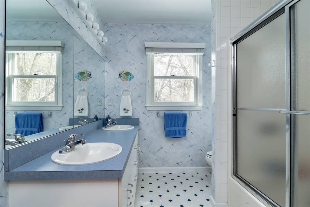 10 Sundance Way Natick, MA 01760 - Photo 30 of 40 a bathroom with a sink a mirror and a shower