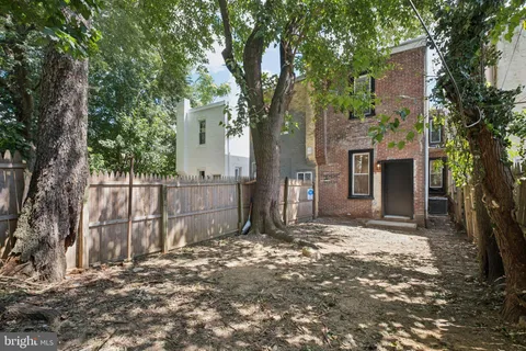 a view of a house with a tree in the background