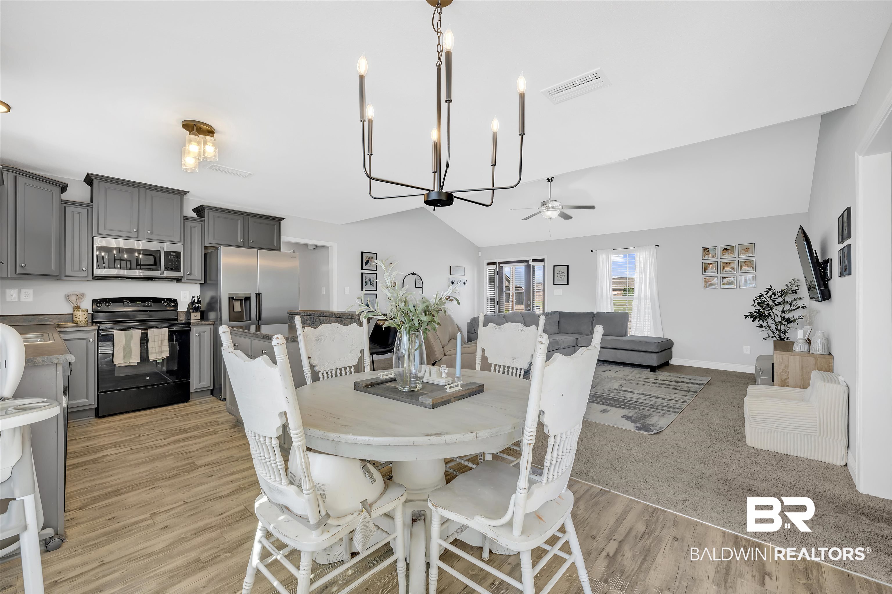 15570 Medway Court Foley, AL 36535 - Photo 5 of 25 Dining space with a chandelier, vaulted ceiling, light wood-type flooring, and a ceiling fan