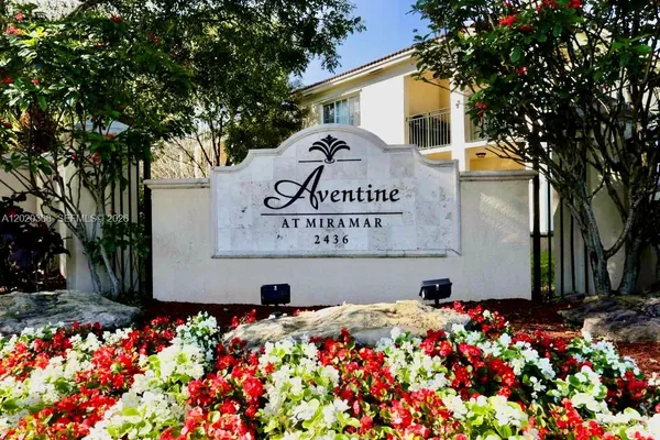 a sign that is in front of flowers