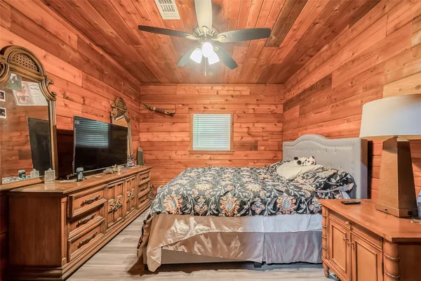 a bedroom with a bed and flat screen tv