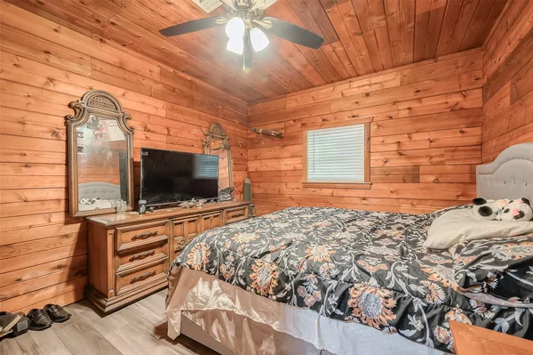 a bedroom with a bed and flat screen tv