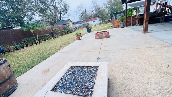 a view of a patio with a table and chairs potted plants