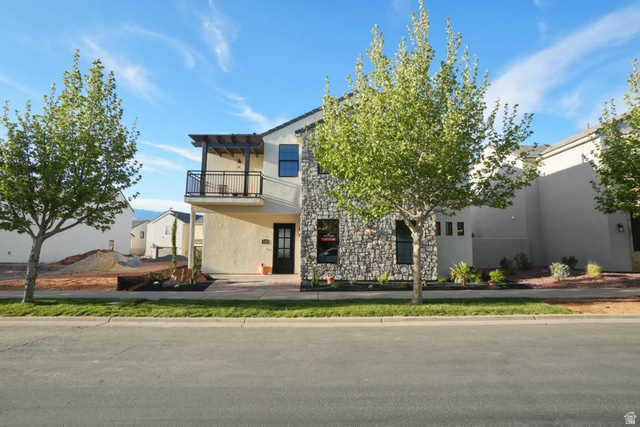 4346 Canterbury Road Hurricane, UT 84737 - Photo 37 of 37 View of front of home featuring a balcony, stone siding, and stucco siding