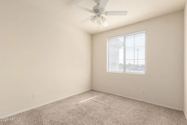 an empty room with a ceiling fan