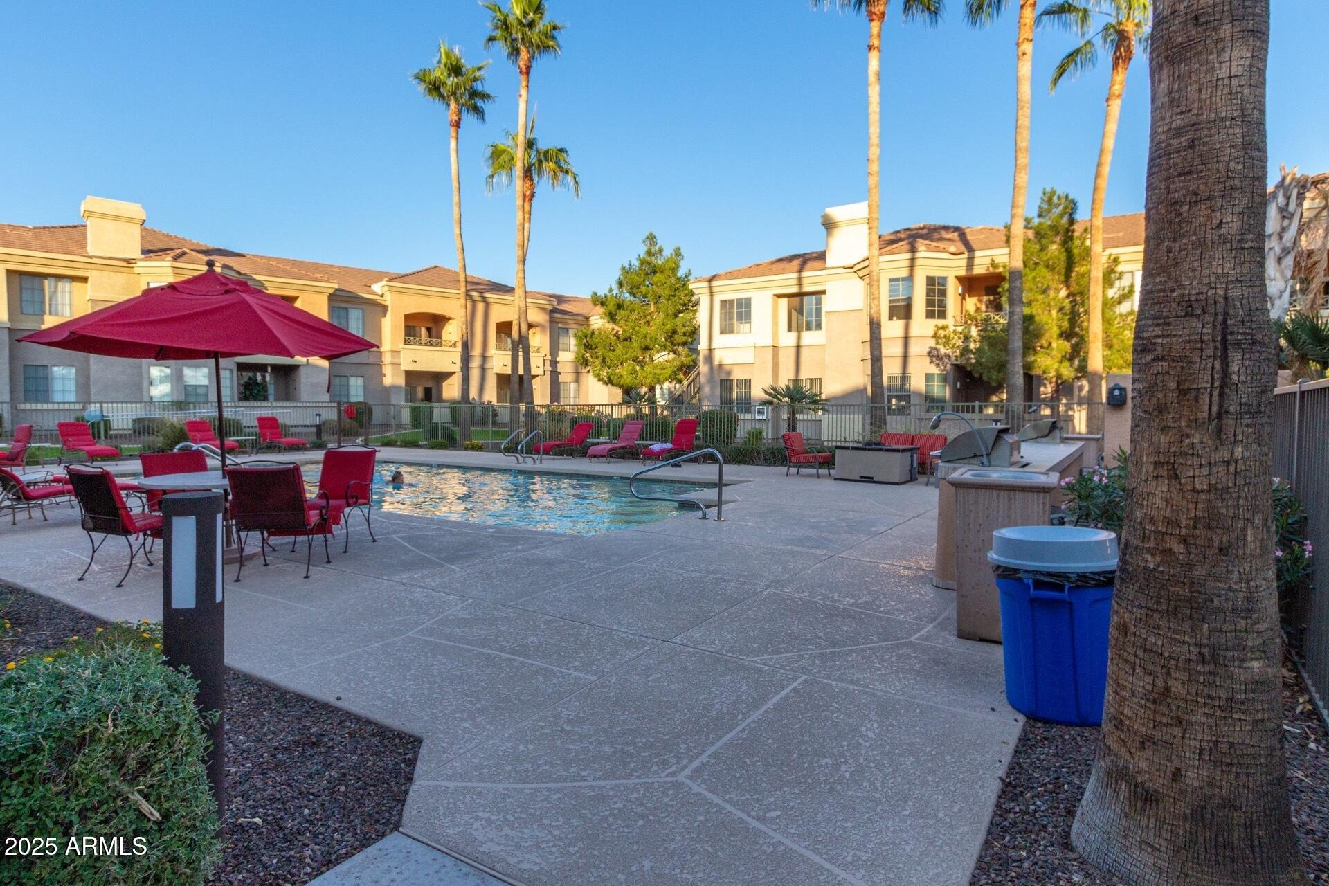 1941 South Pierpont Drive, Unit 2141 Mesa, AZ 85206 - Photo 23 of 29 a view of the patio with a table and chairs under an umbrella