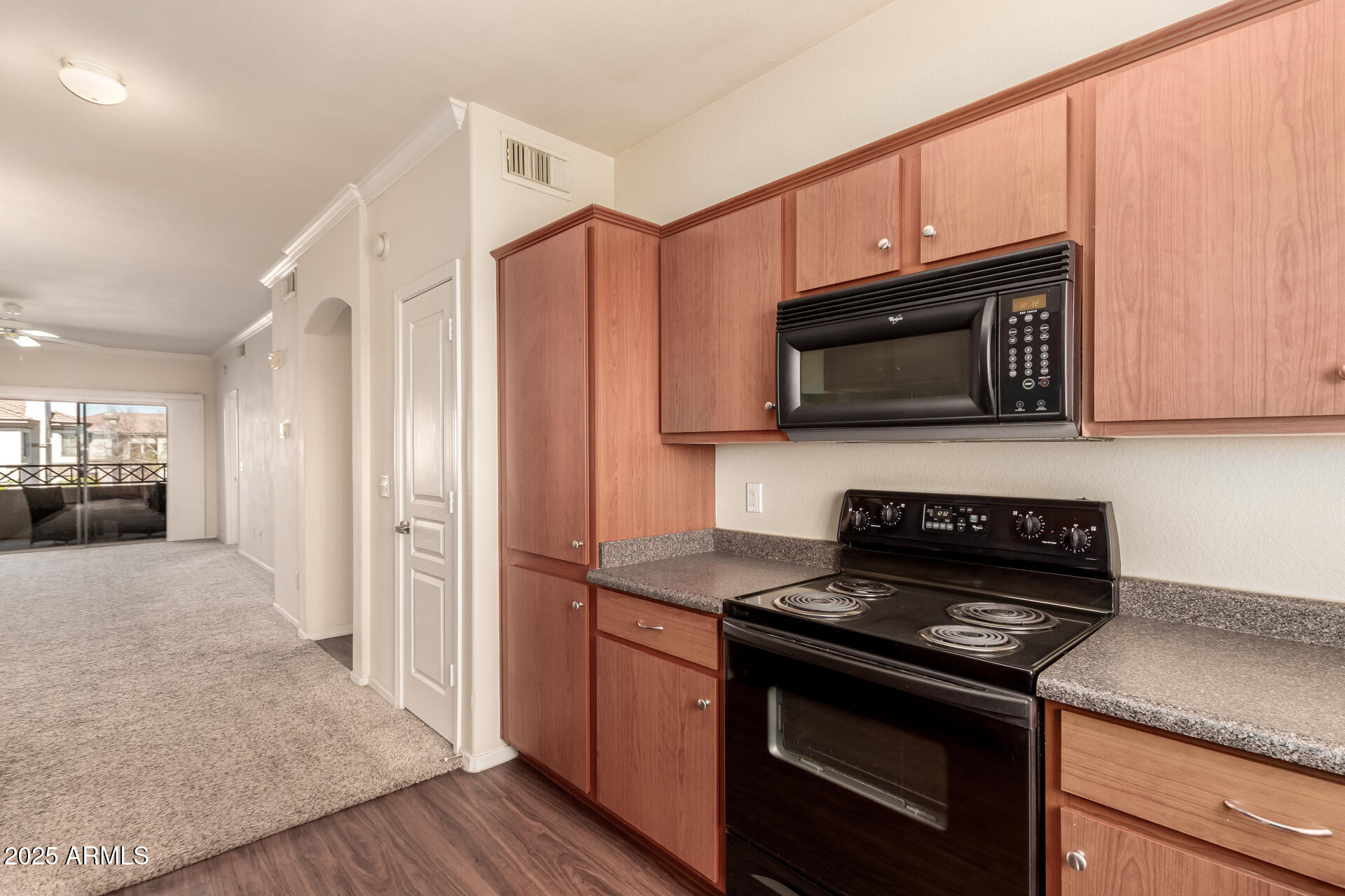 1941 South Pierpont Drive, Unit 2141 Mesa, AZ 85206 - Photo 7 of 29 a kitchen with stainless steel appliances granite countertop a stove microwave and refrigerator