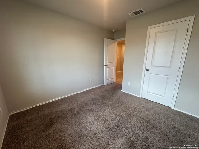 a view of an empty room and closet area