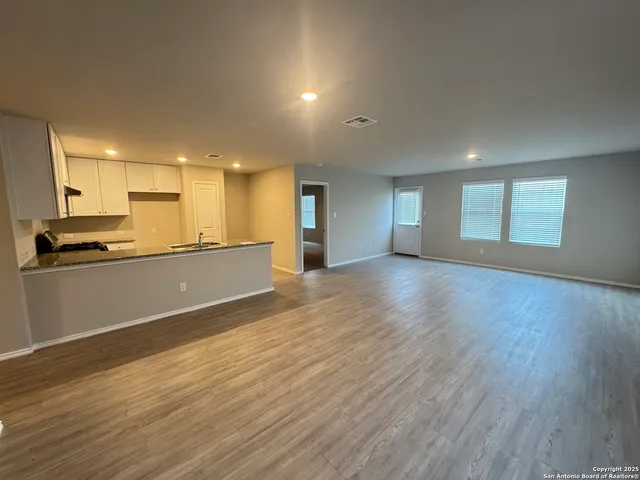 a view of a kitchen with a sink and a stove top oven