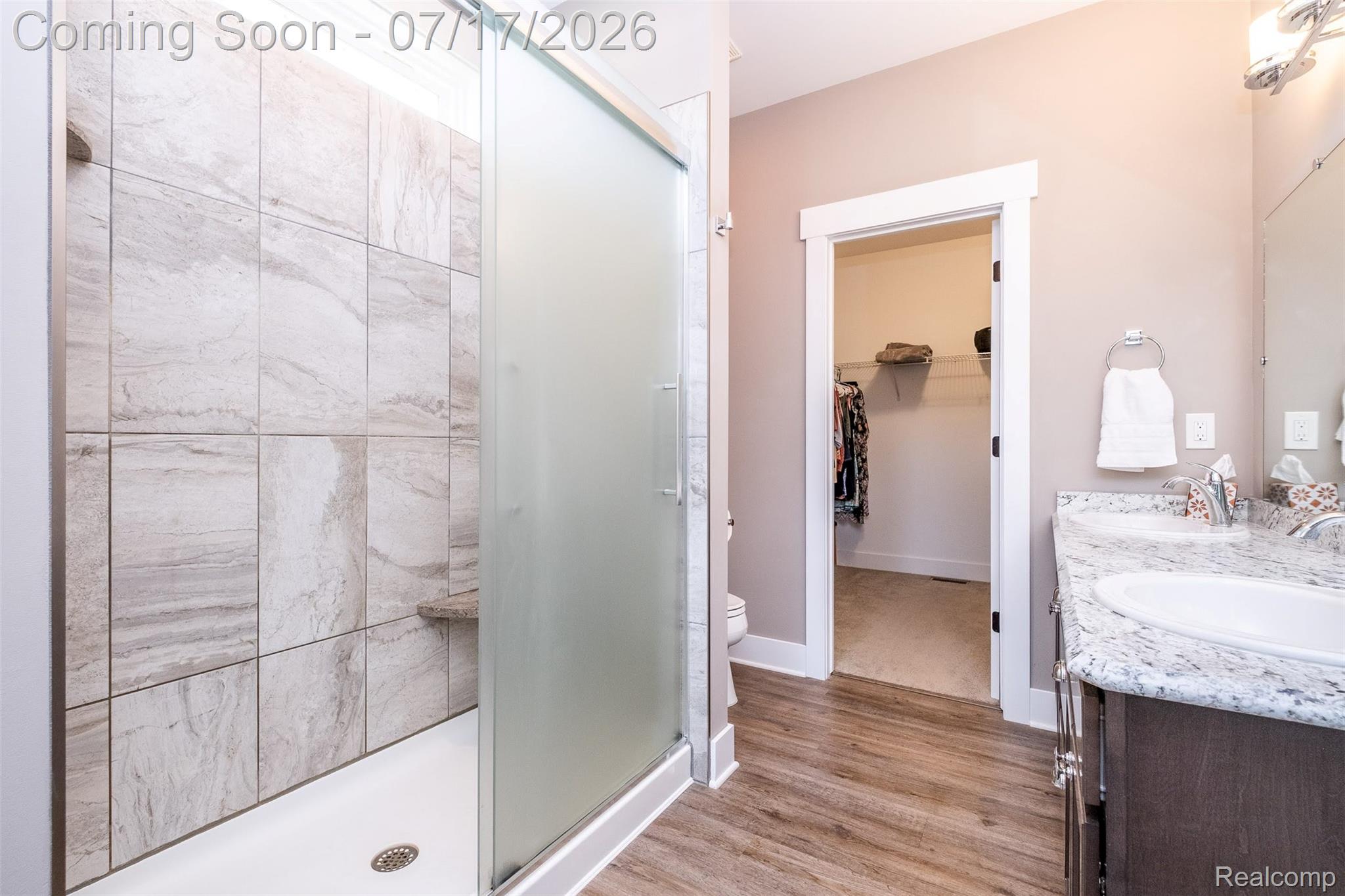 12349 Sugar Maple Drive Fenton, MI 48430 - Photo 28 of 67 Walk-in shower featuring a frosted glass door and integrated bench