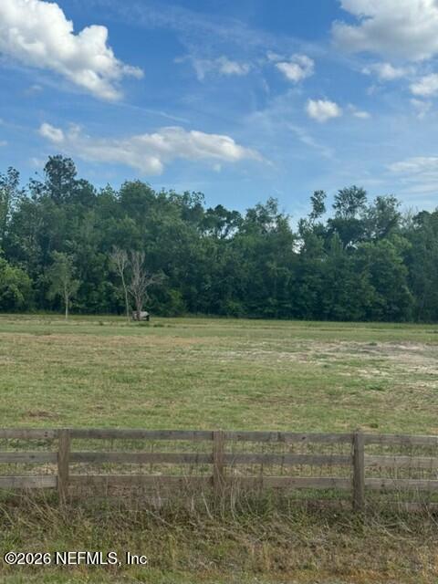 a view of a field with an ocean