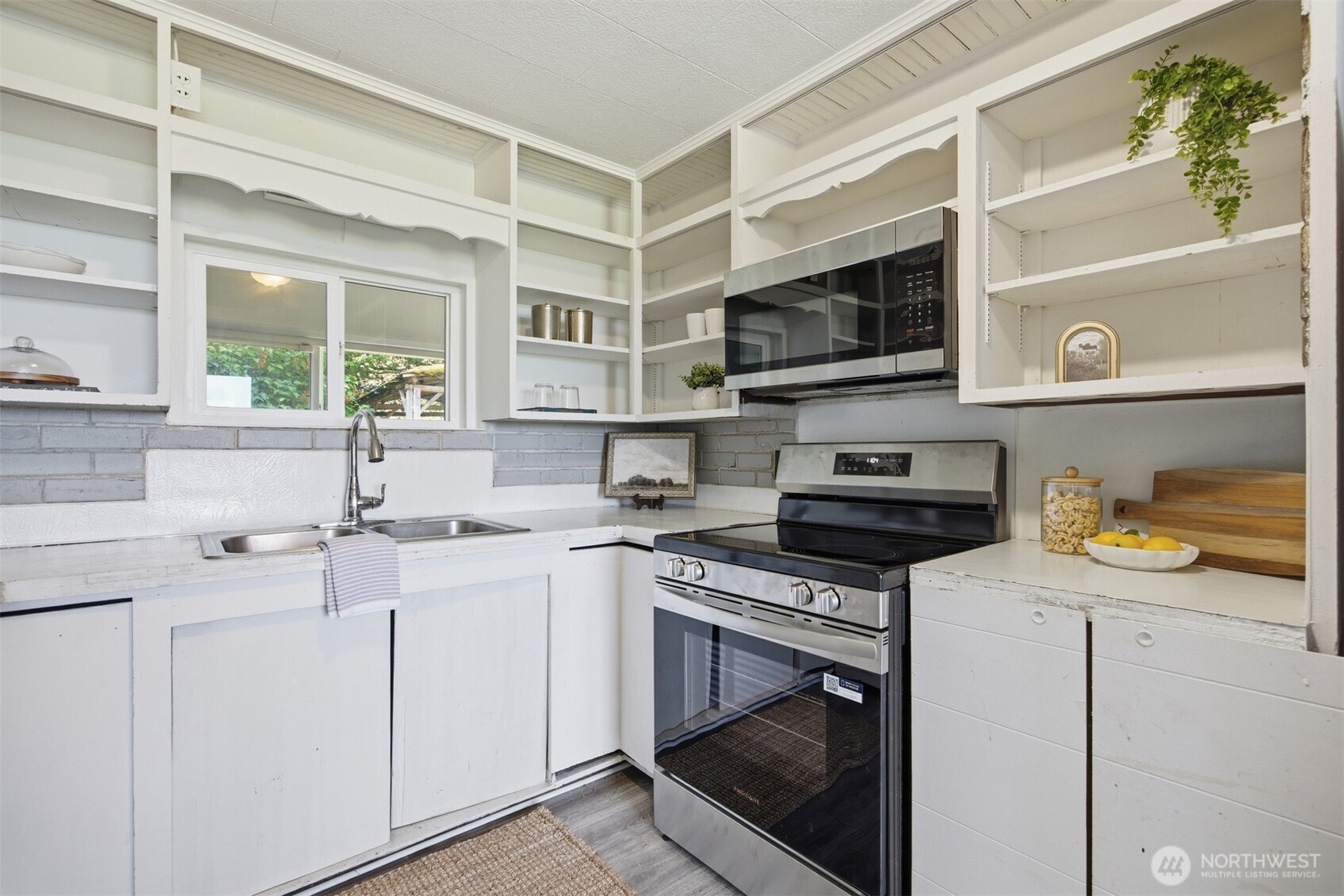 6791 Noon Road Everson, WA 98247 - Photo 12 of 38 a kitchen with stainless steel appliances a stove a sink and a microwave