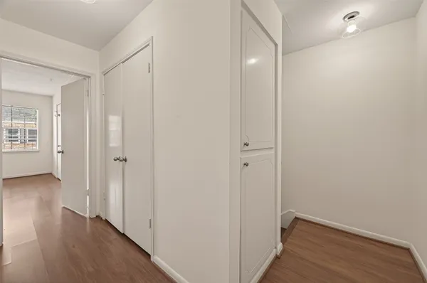 a view of hallway with wooden floor