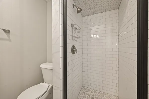 a white toilet sitting next to a bathroom sink