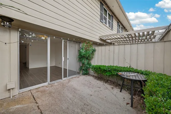 a backyard of a house with a garden and outdoor seating