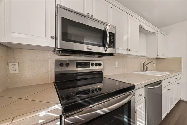 a kitchen with a stove and a microwave