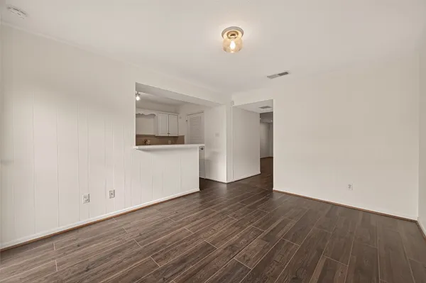 a view of a kitchen with wooden floor and a sink