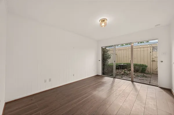 a view of a livingroom with wooden floor and a window